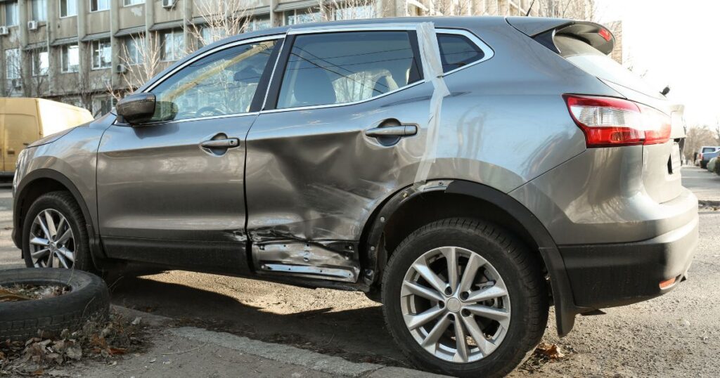 gray car with damaged side after a hit and run accident