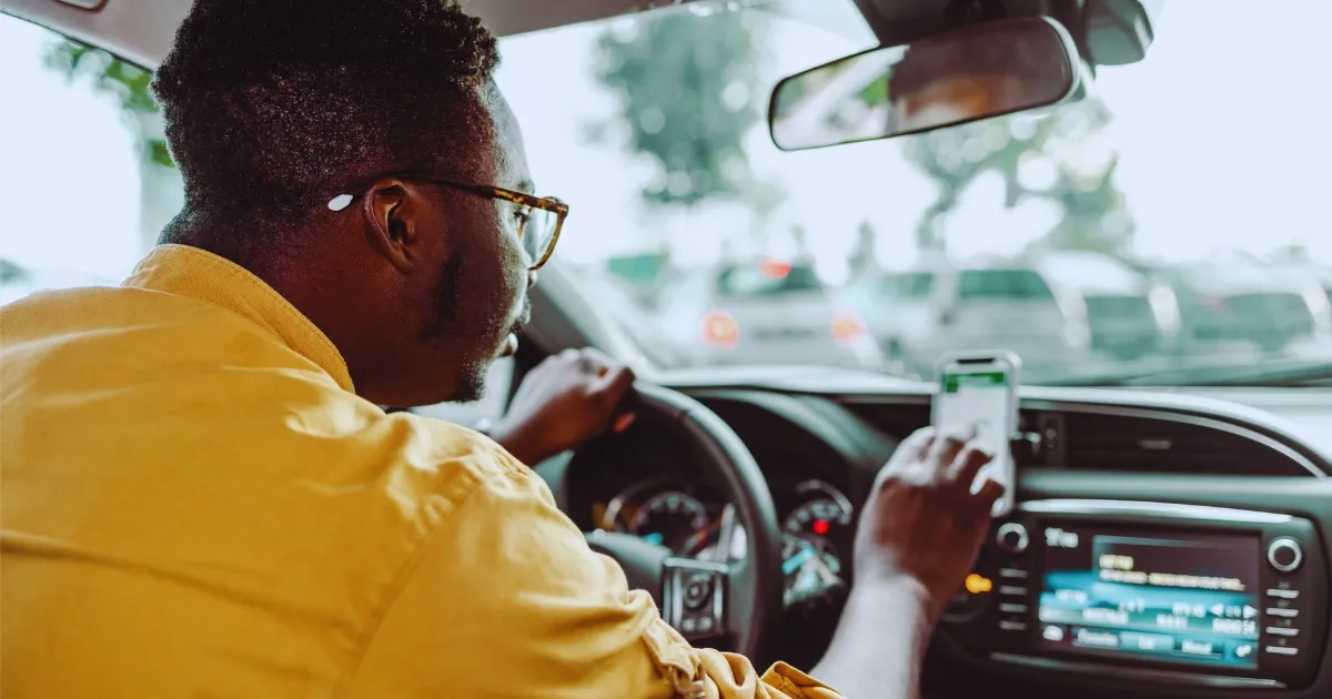 Uber driver on their phone representing how fault is determined in rideshare accidents in Bergen County NJ